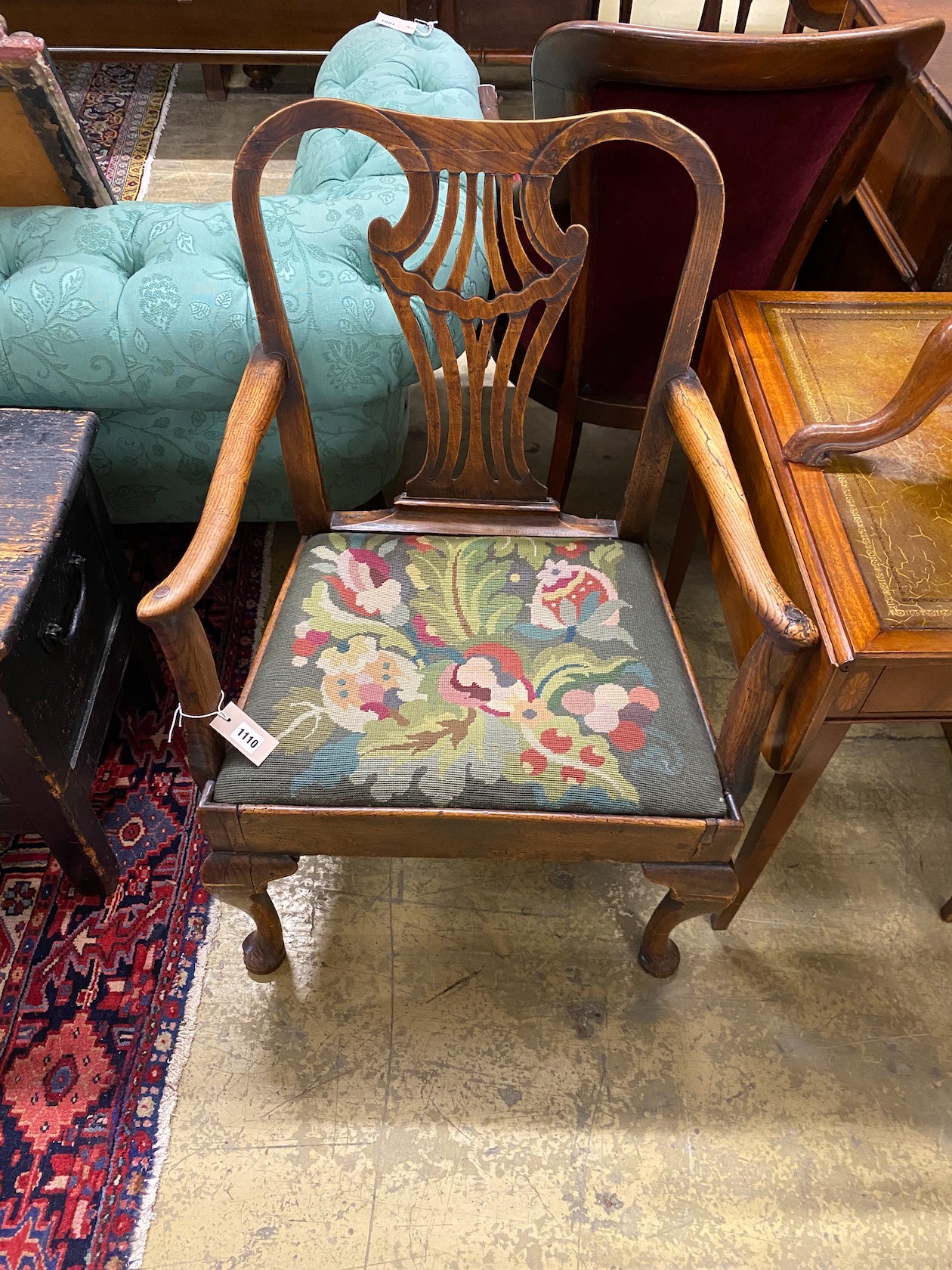 A George III provincial elm seat elbow chair with tapestry upholstered drop in seat, width 66cm, depth 47cm, height 94cm